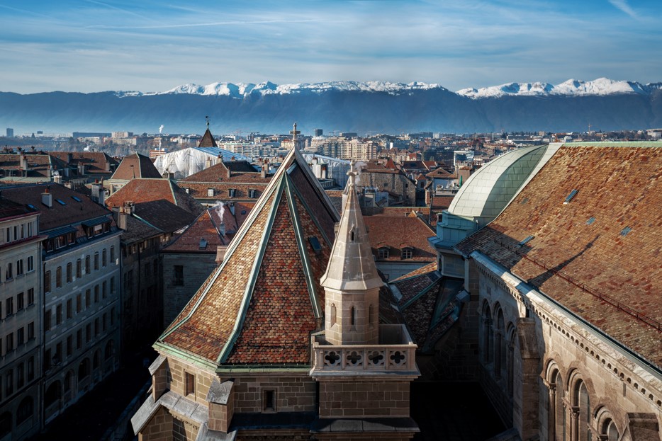 The cathedral roofs of Geneva, with the Alps beyond